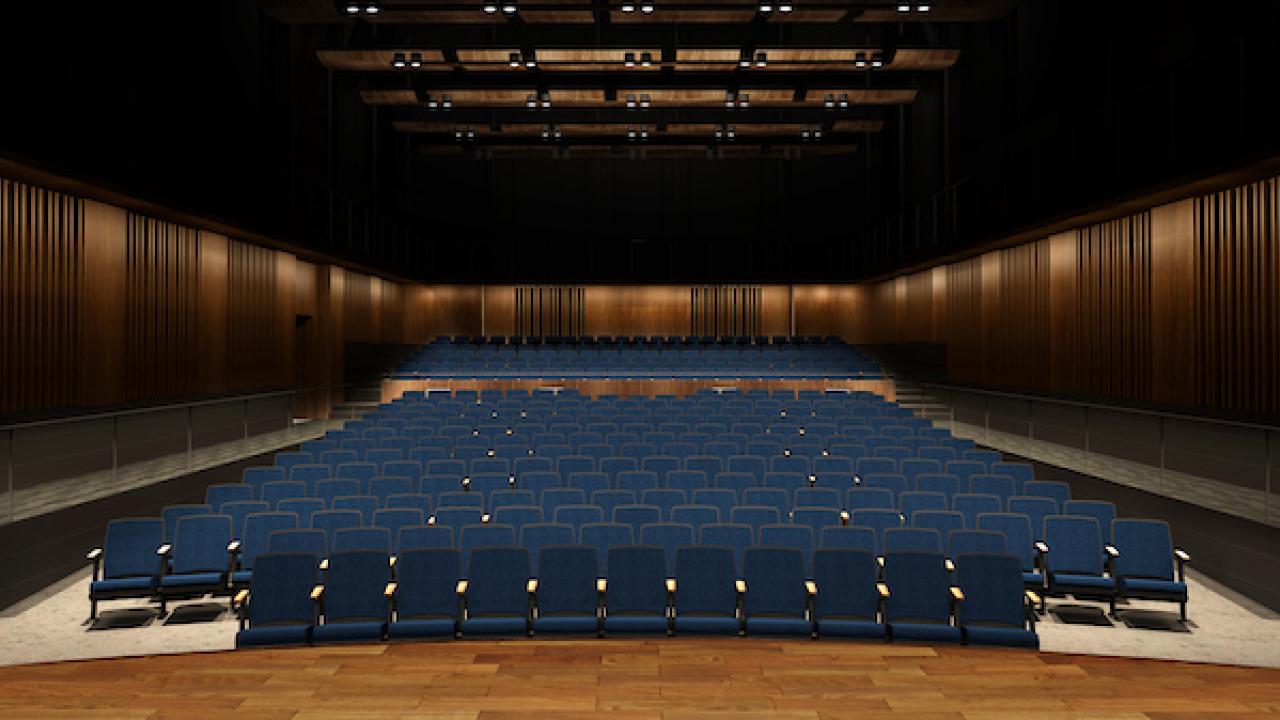 View from the front of an empty room with theatre style seats in it