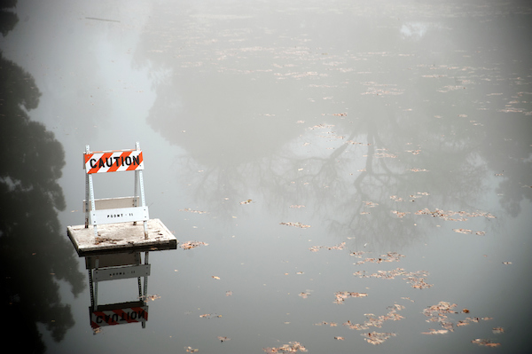 Hazard sign in the middle of a puddle